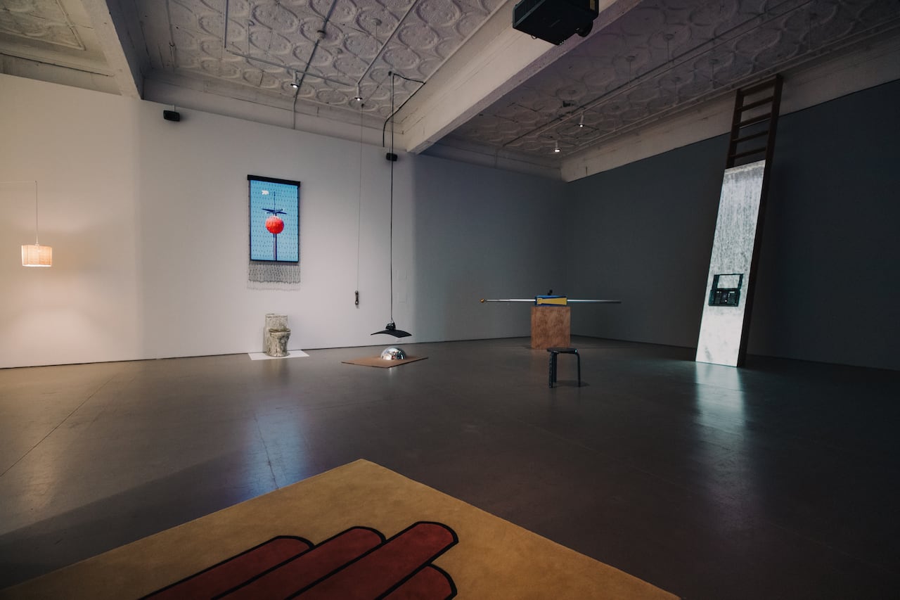 Sculptural object, including a toilet and wood.