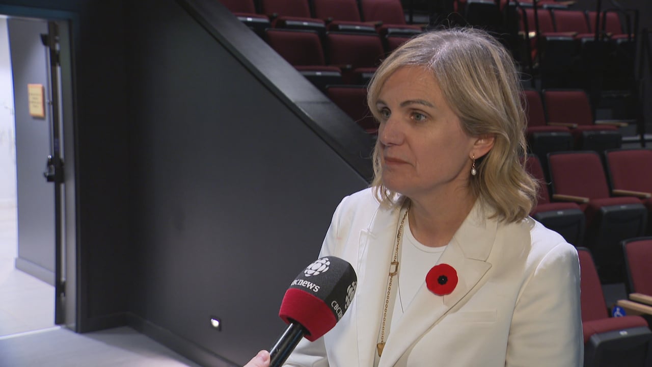 A woman in a white blazer.