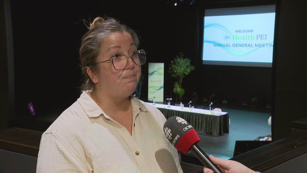 A woman with glasses and a white shirt.