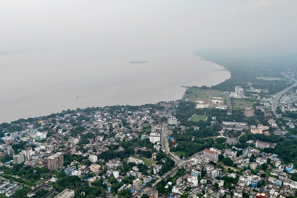 This aerial photograph taken on September 22, 2025, shows a general view of river Padma shrouded in mist at Rajshahi. In the swamplands along Bangladesh's mighty Padma River, snakes slithering through villages have become an unrelenting menace, leaving residents terrified and hospitals overwhelmed with bite victims. — AFP pic