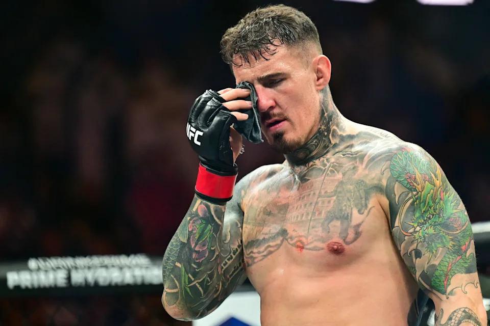 Britain's Tom Aspinall reacts after being hit in the eye while fighting  France's Ciryl Gane during their UFC heavyweight title bout at UFC 321 at Etihad Arena in Abu Dhabi early on October 26, 2025. (Photo by Giuseppe CACACE / AFP) (Photo by GIUSEPPE CACACE/AFP via Getty Images)