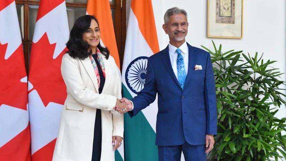 Canadian Foreign Minister Anita Anand met her Indian counterpart S Jaishankar on Monday. They are seen shaking hands with the flags of India and Canada in the background.