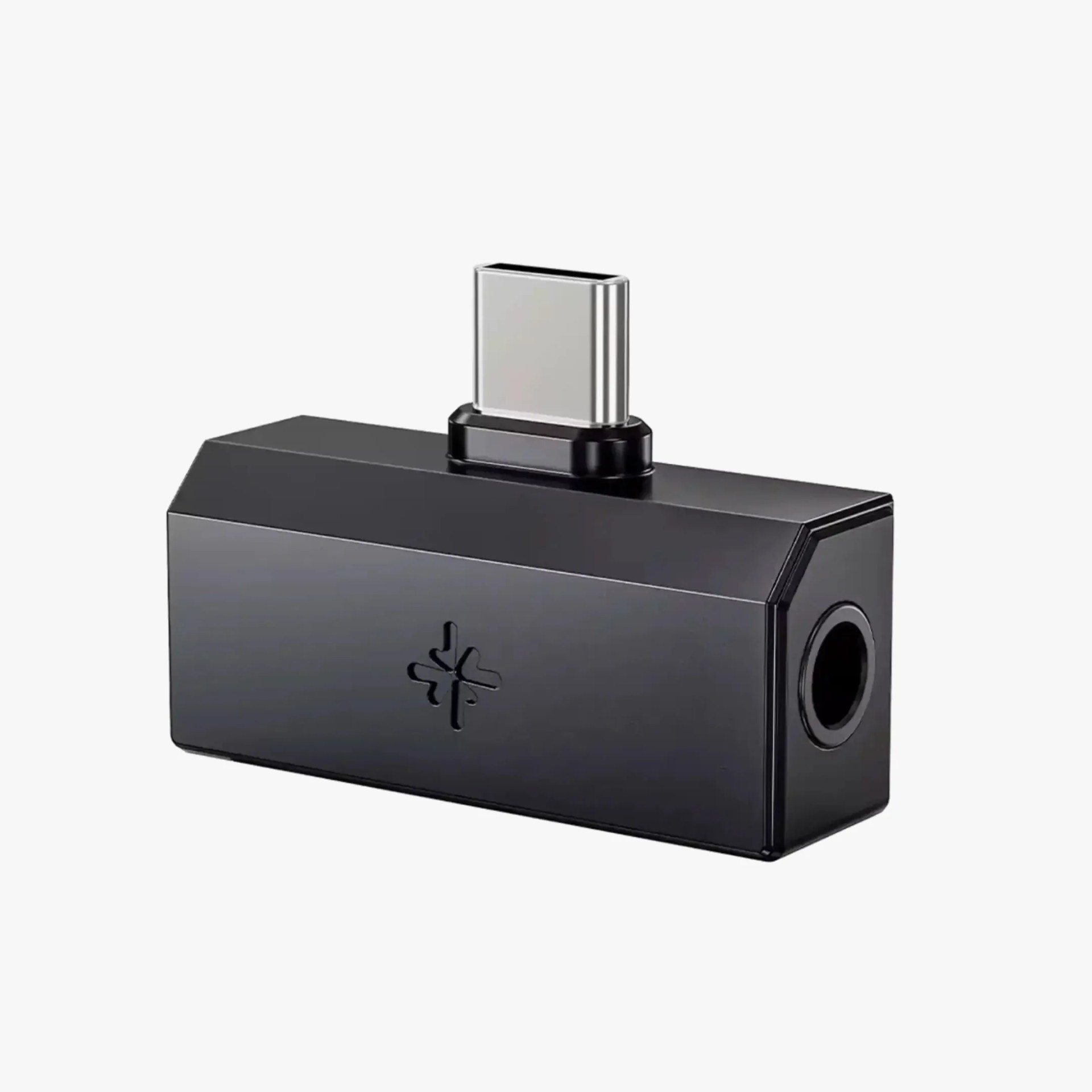 Black rectangular USB-C to 3.5mm headphone jack adapter with a small logo on the side.