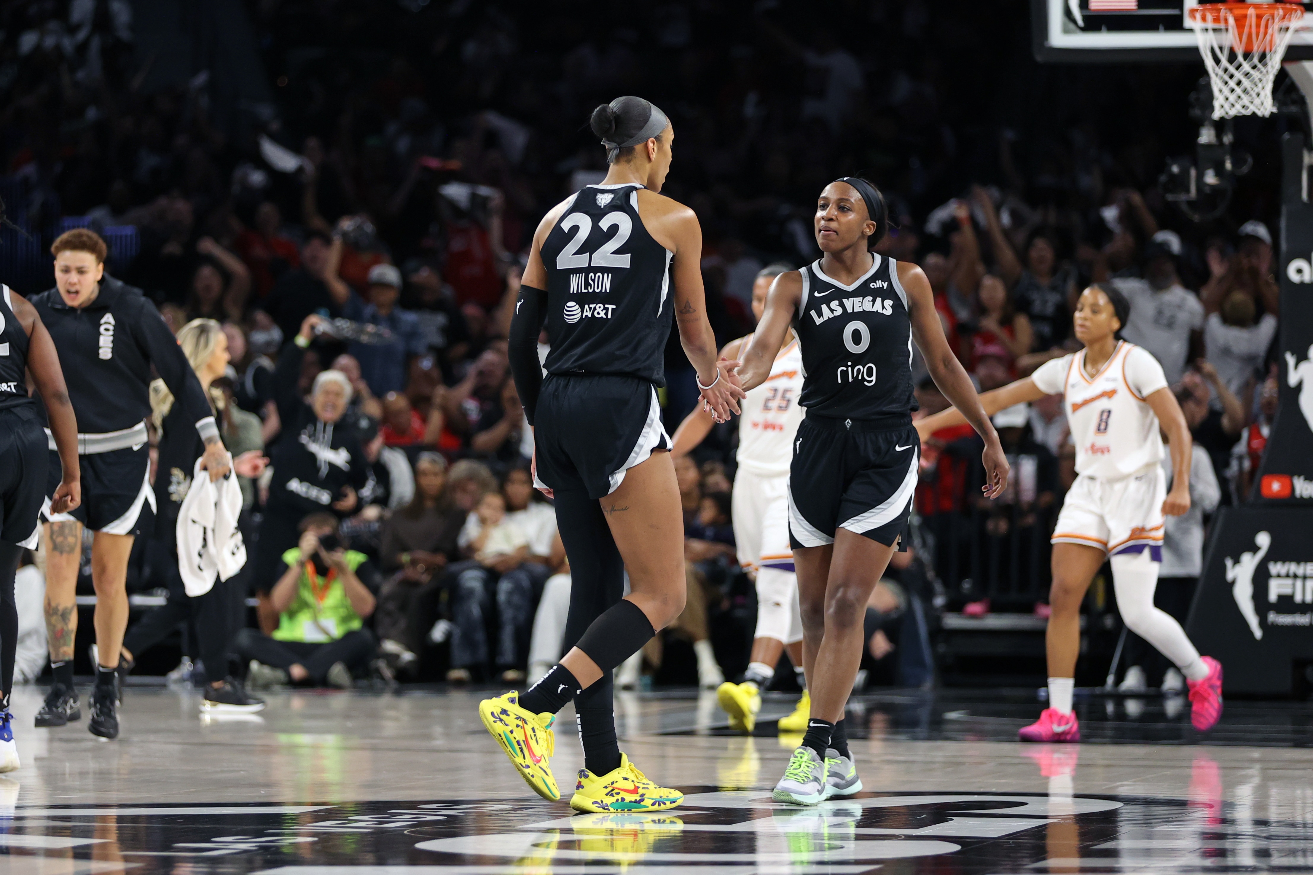 A'ja Wilson #22 high fives Jackie Young #0 of the Las Vegas Aces during the game against the Phoenix Mercury during Game 2 of the 2025 WNBA Finals