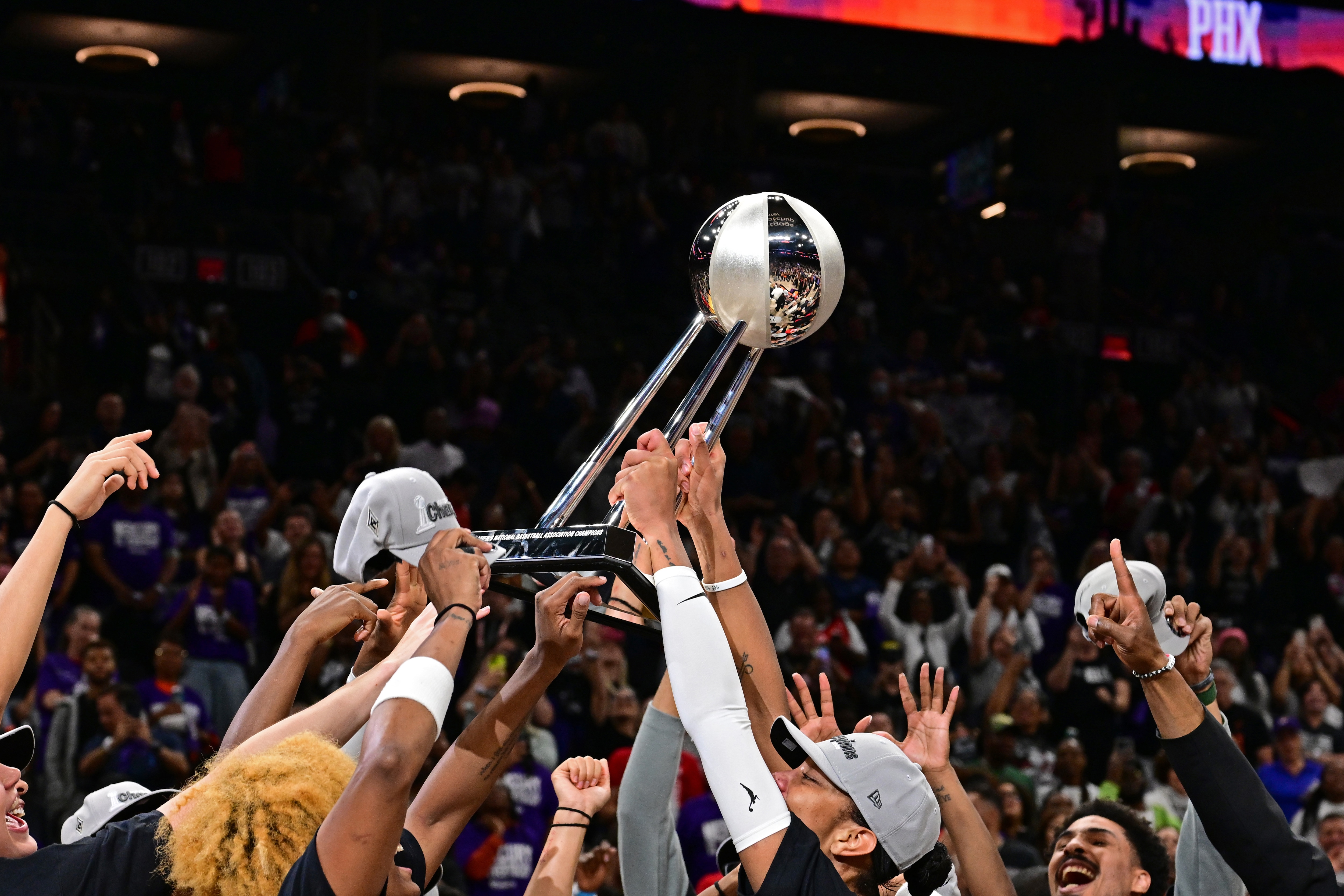 The Las Vegas Aces players holds up the 2025 WNBA Championship trophy after winning against the Phoenix Mercury during Game 4 of the 2025 WNBA Finals