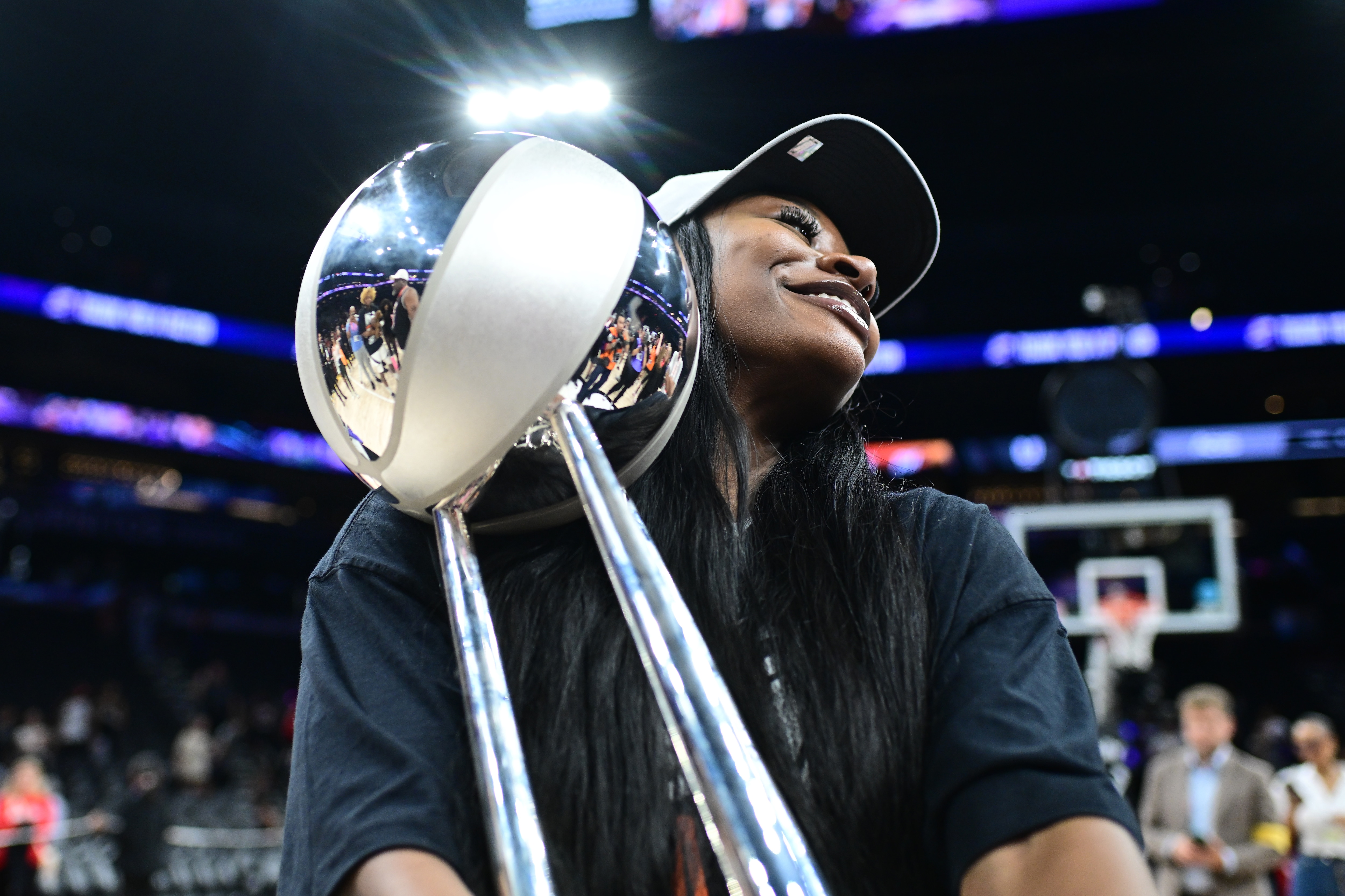 Dana Evans #11 of the Las Vegas Aces holds up the 2025 WNBA Championship trophy