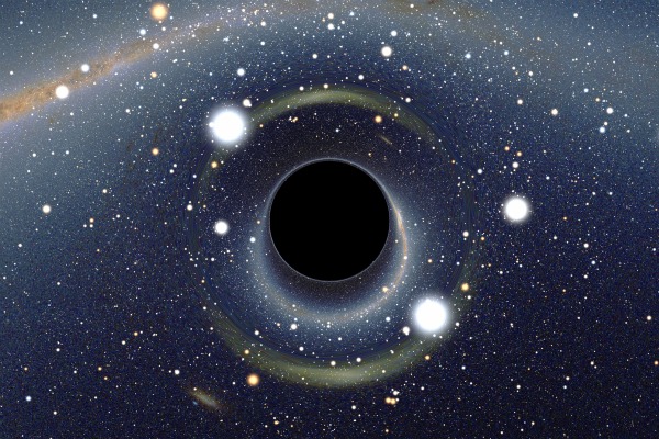 A swirl of starry material forms a black hole in the center of the image.
