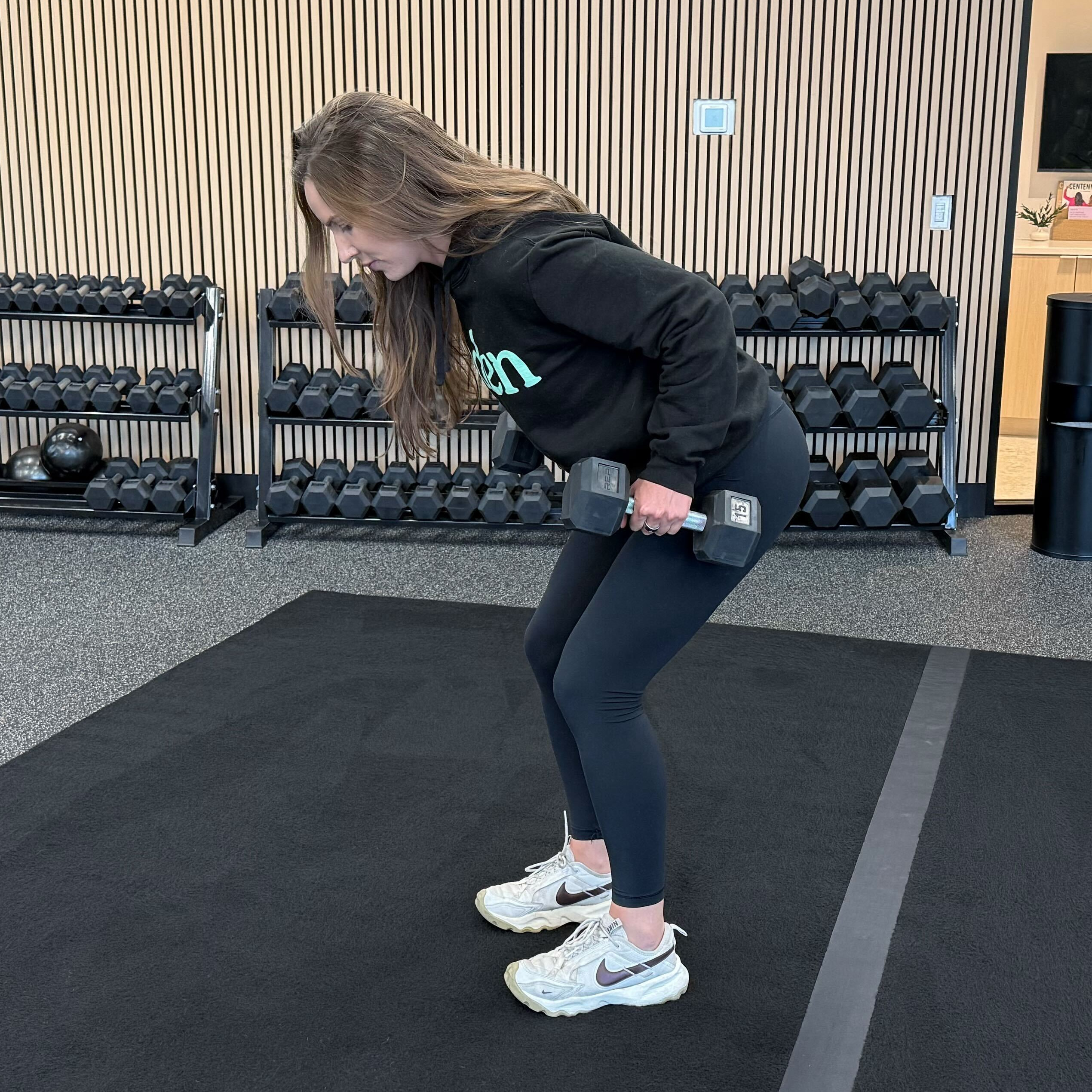 Felicia Hernandez, a personal trainer for Eden Health Club, perform a bent over row in a fitness studio.