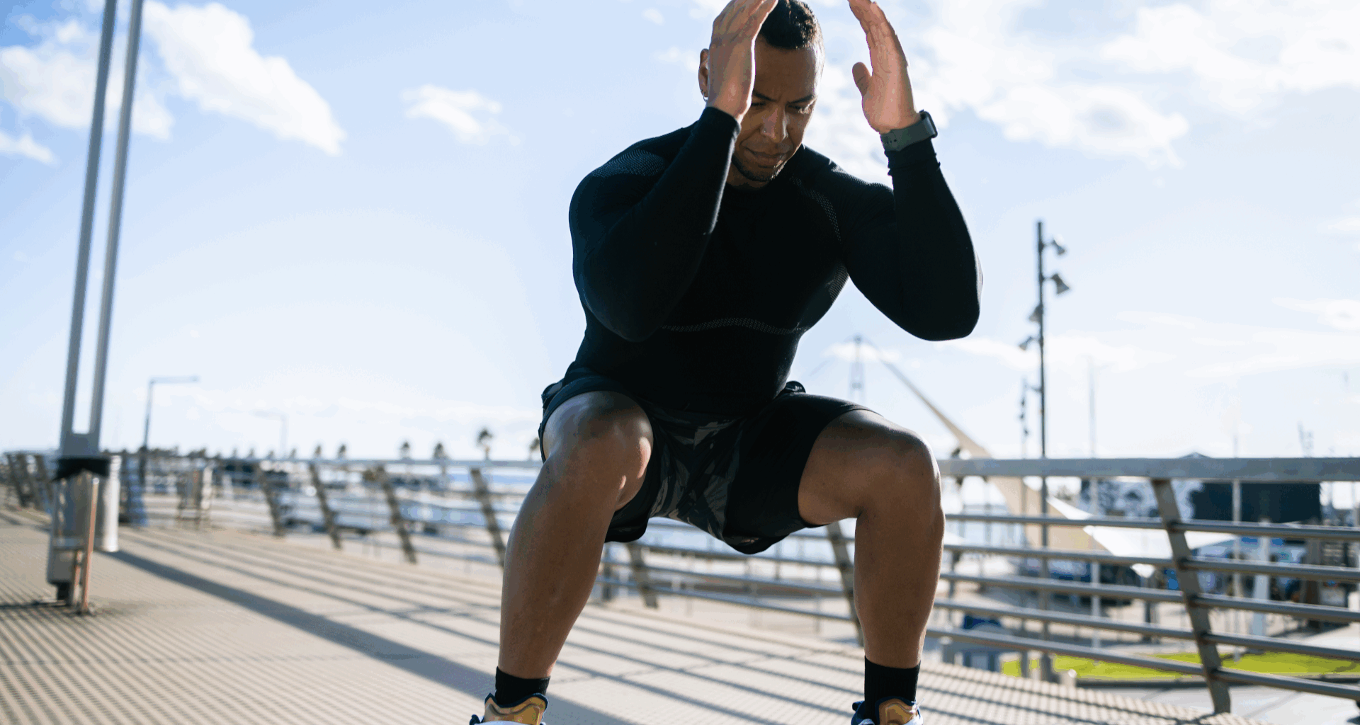 A man doing a squat outdoors