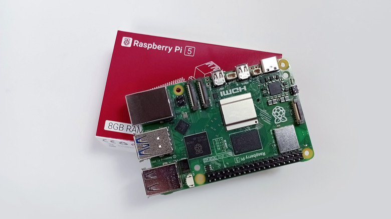 Raspberry Pi board on top of red packaging box