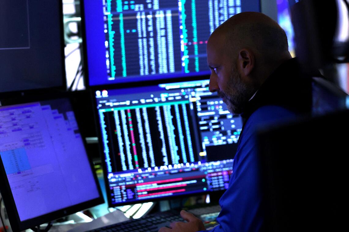 A trader works on the floor of the New York Stock Exchange (NYSE) at the opening bell on October 1, 2025, in New York City. Wall Street stocks mostly fell early Wednesday as the US government officially entered a partial shutdown following a stalemate in budget talks. (Photo by TIMOTHY A. CLARY / AFP)