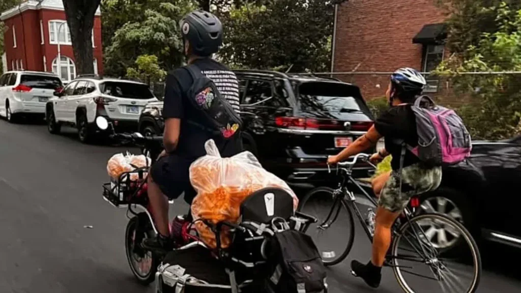 Cyclists carrying food they've bought from street vendors