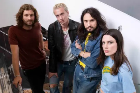 BBC Wolf Alice pose on a staircase at the BBC's New Broadcasting House in August 2025 (L-R): Joff Oddie, Theo Ellis, Joel Amey and Ellie Rowsell