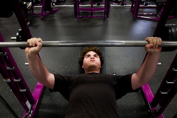 Salim Sarkis, 17, goes through a weights exercise at Planet Fitness.