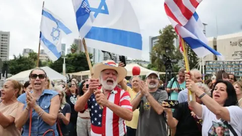 EPA People gather at the "Hostages square" after U.S. President Donald Trump announced that Israel and Hamas agreed on the first phase of a Gaza ceasefire, in Tel Aviv, Israel, October 9, 2025.