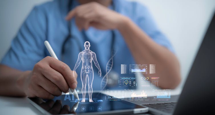 A person writes on a tablet using a stylus. There is an anatomical human body popping out from the tablet.