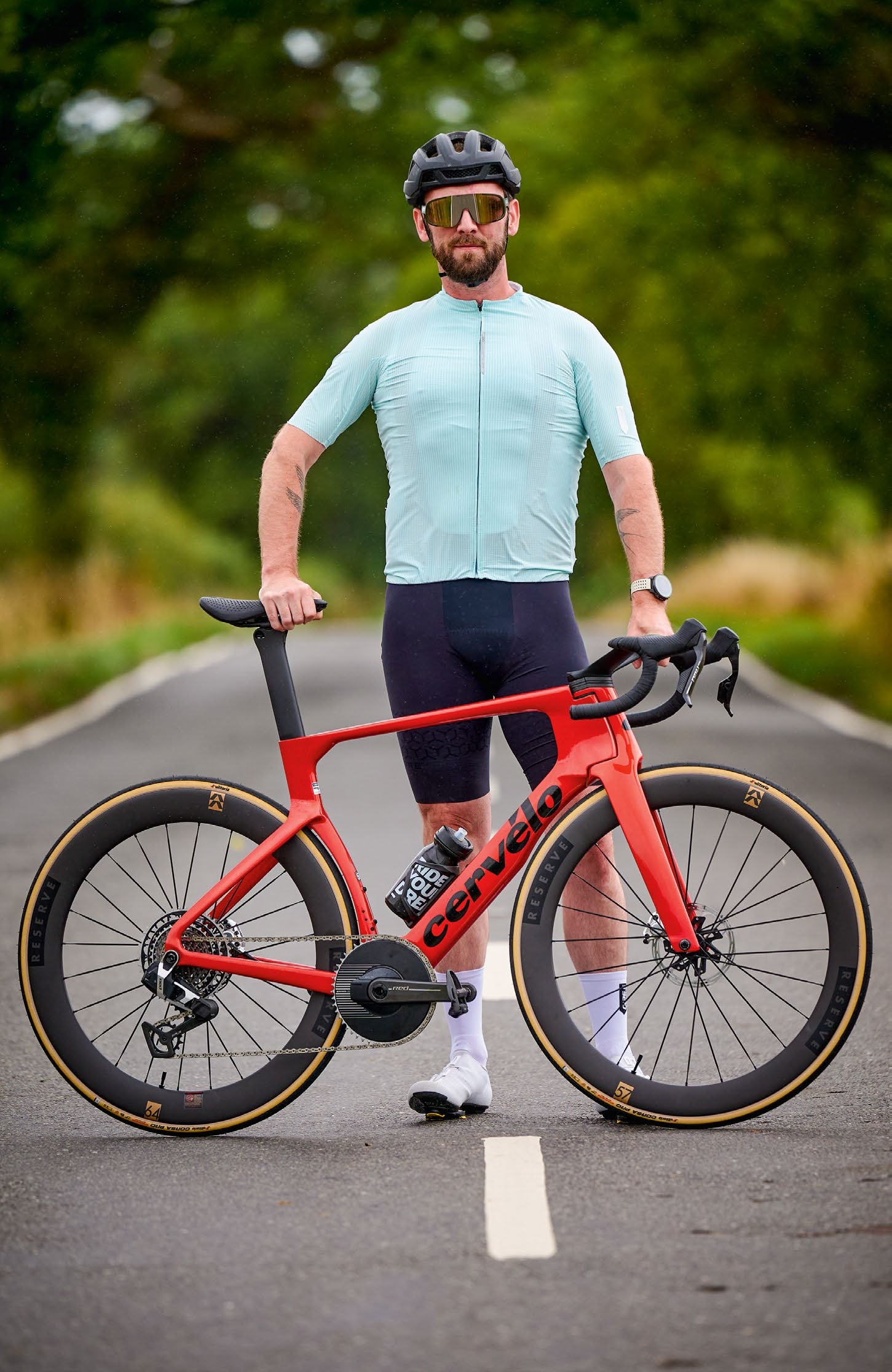 Andy Carr standing with a Cervelo bike