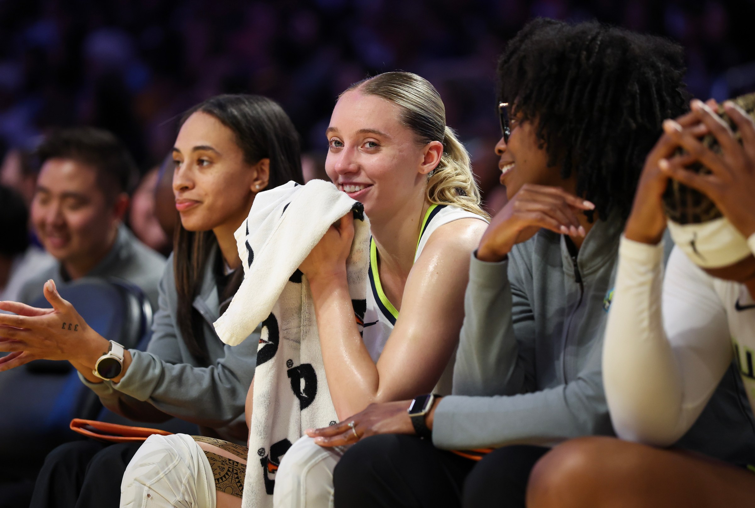 Paige Bueckers with Dallas Wings assistant coaches Nola Henry and Camille Smith.