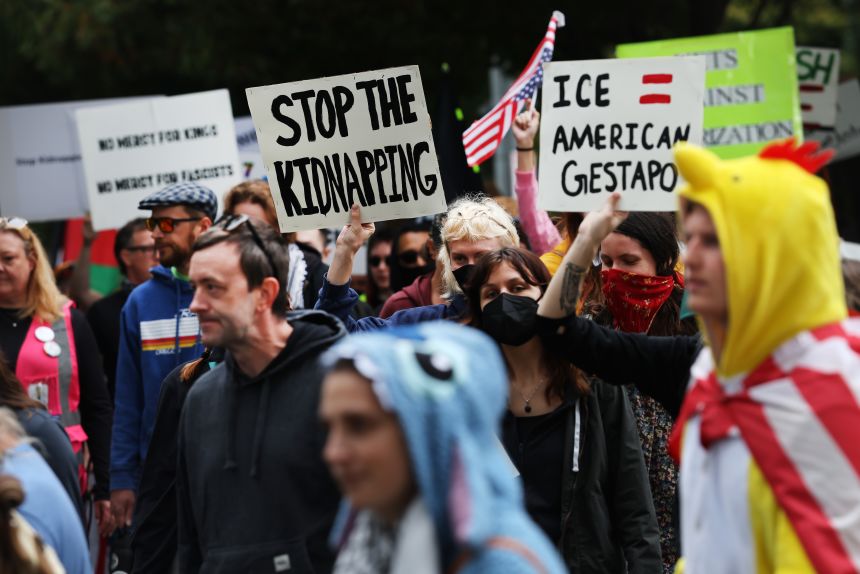 Protesters head toward a downtown US Immigration and Customs Enforcement (ICE) facility in Portland, Oregon, on Saturday.