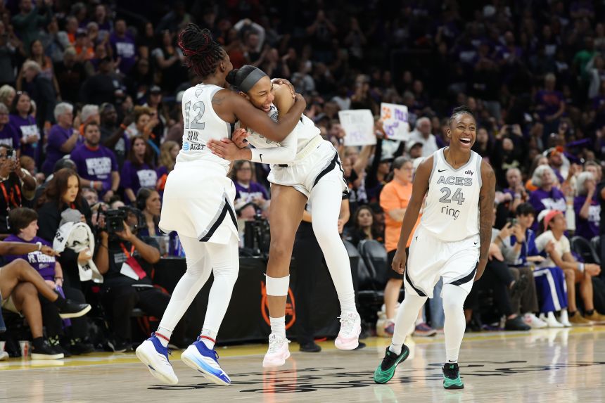 A'ja Wilson celebrates with Chelsea Gray and Jewell Loyd.