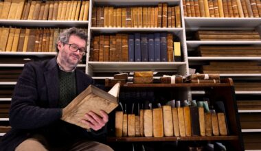 Professor Adrian Streete with the Zachary Boyd library collection. Pic: Martin Shields/University of Glasgow
