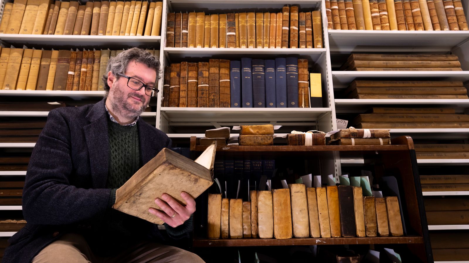 Professor Adrian Streete with the Zachary Boyd library collection. Pic: Martin Shields/University of Glasgow