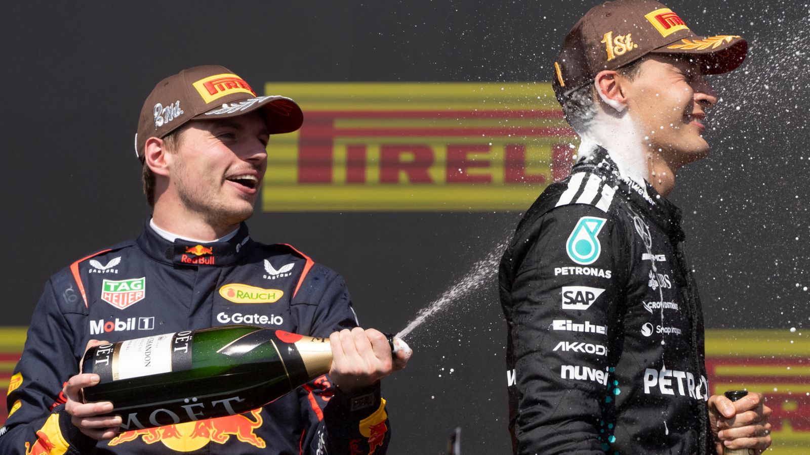 Mercedes driver George Russell, of the United Kingdom, right, is sprayed with champagne by second place Red Bull Racing driver Max Verstappen, of the Netherlands, after winning Formula One auto racing at the Canadian Grand Prix in Montreal, Sunday, June 15, 2025. (Christinne Muschi/The Canadian Press via AP)