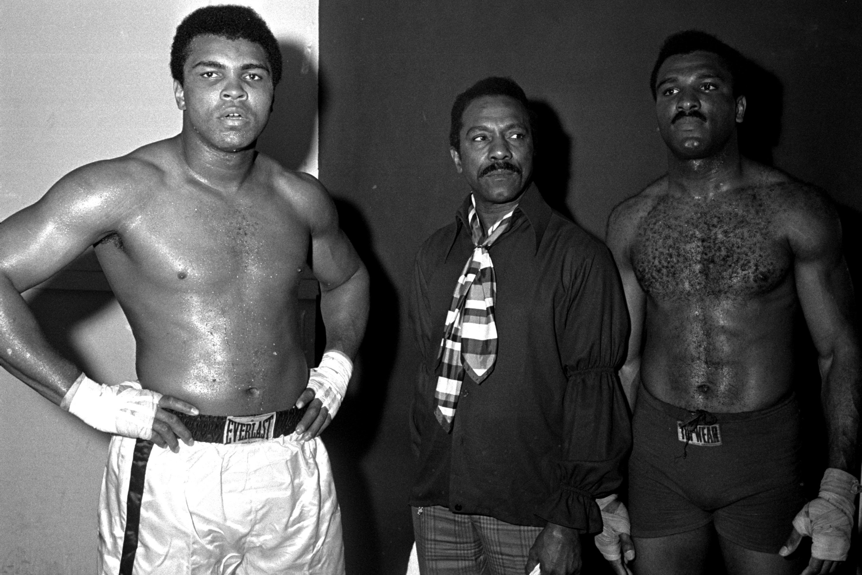 Boxing champion Muhammad Ali, his father Cassius Clay, Sr., and his brother Rahaman Ali at a training camp.