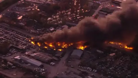 CBS An aerial shot of burning buildings after a plane crash at Louisville Airport
