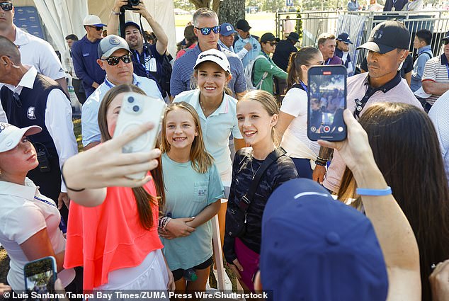 The president's granddaughter poses for photos with young fans following her round