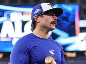 Davis Schneider of the Toronto Blue Jays takes batting practice during the playoffs.