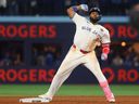 Vladimir Guerrero Jr. of the Toronto Blue Jays reacts after hitting a double during Game 7 against the Los Angeles Dodgers.