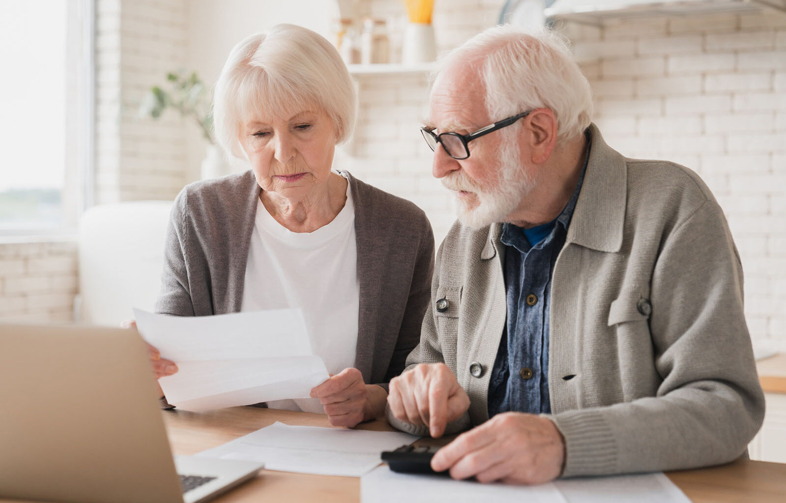 Serious caucasian old elderly senior couple grandparents family counting