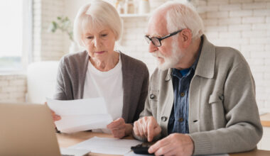 Serious caucasian old elderly senior couple grandparents family counting