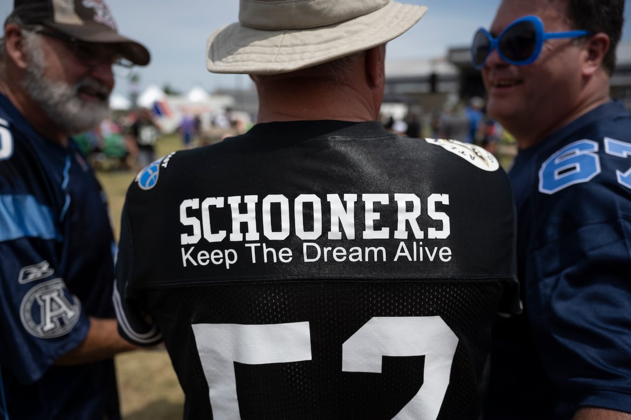 A CFL fan wears a jersey that says, "Schooners: Keep The Dream Alive," a reference to a proposed CFL franchise for Halifax.
