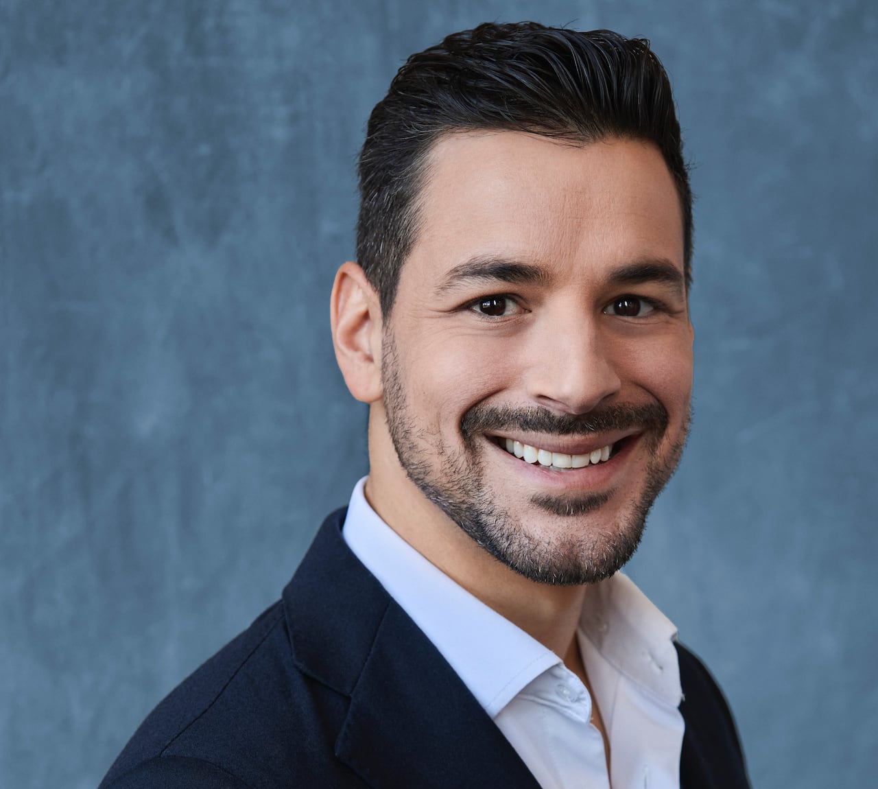 A portrait of a smiling man.