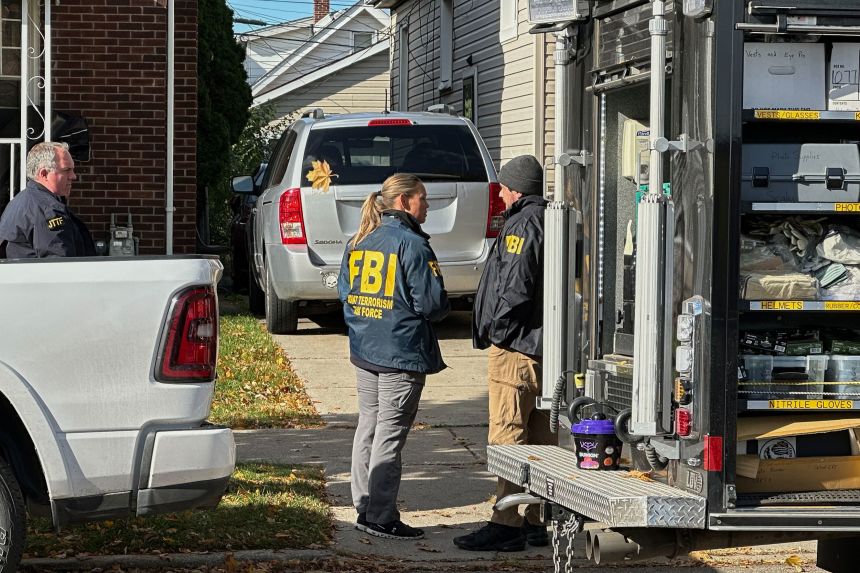 FBI agents gather outside a home in a Dearborn, Michigan, neighborhood on October 31.
