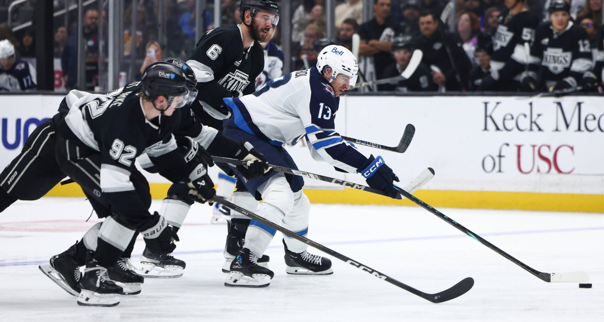 Winnipeg Jets centre Gabriel Vilardi (13) battles for the puck against Los Angeles Kings defenseman Brandt Clarke (92), left wing Jeff Malott, second from left, and defenseman Joel Edmundson (6) during the third period of an NHL hockey game, Tuesday, Nov. 4, 2025, in Los Angeles. (Jessie Alcheh / The Associated Press)