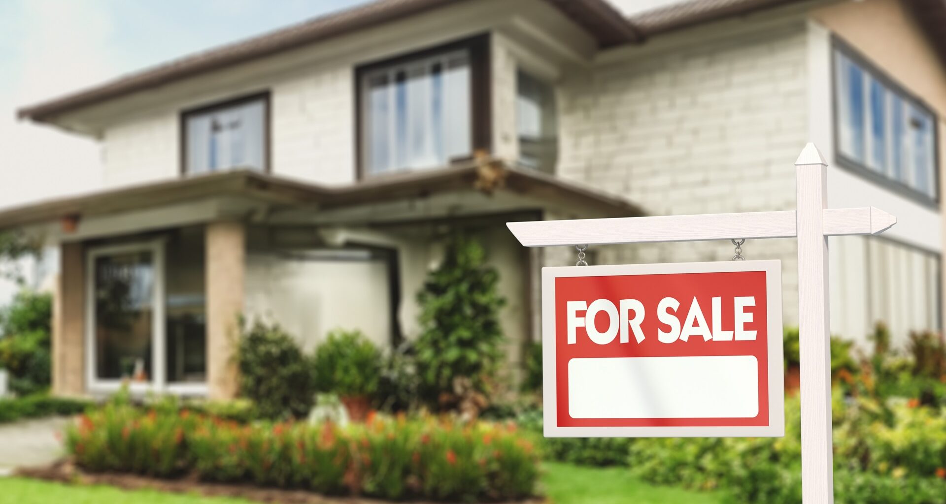 Real Estate Sign in Front of a House with a Garden for Sale stock photo