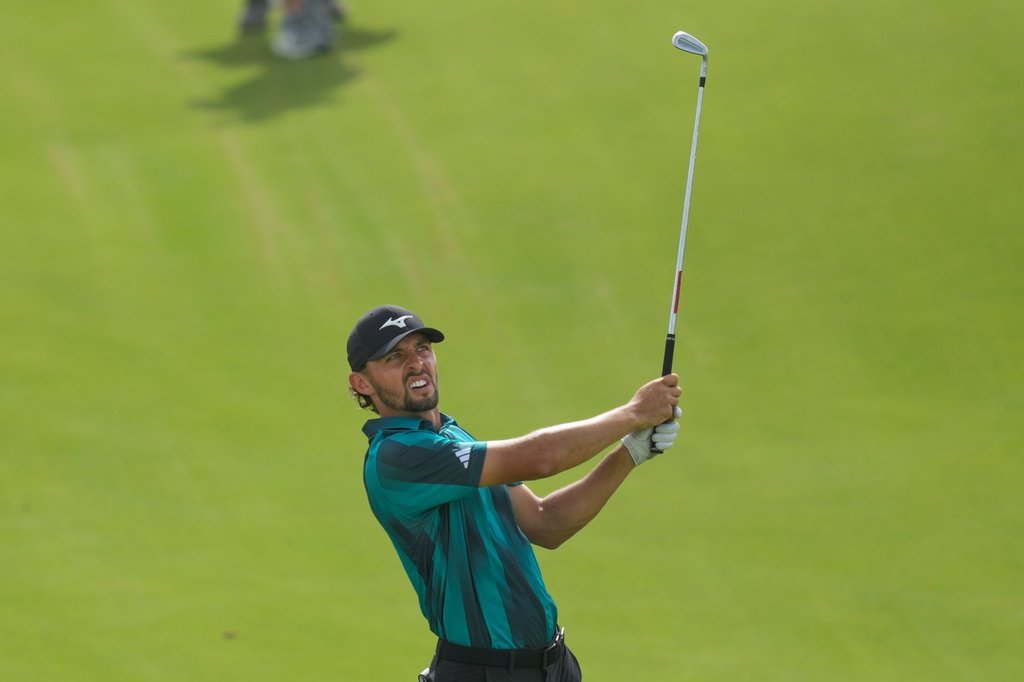 Marco Penge of England watches after playing his second shot on the 17th hole during the first round of Abu Dhabi Golf Championship in Abu Dhabi, United Arab Emirates, Thursday, Nov. 6, 2025. (AP Photo/Altaf Qadri)