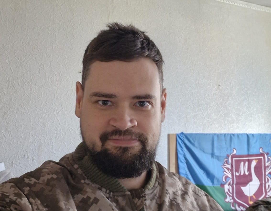 A man looks at the camera.