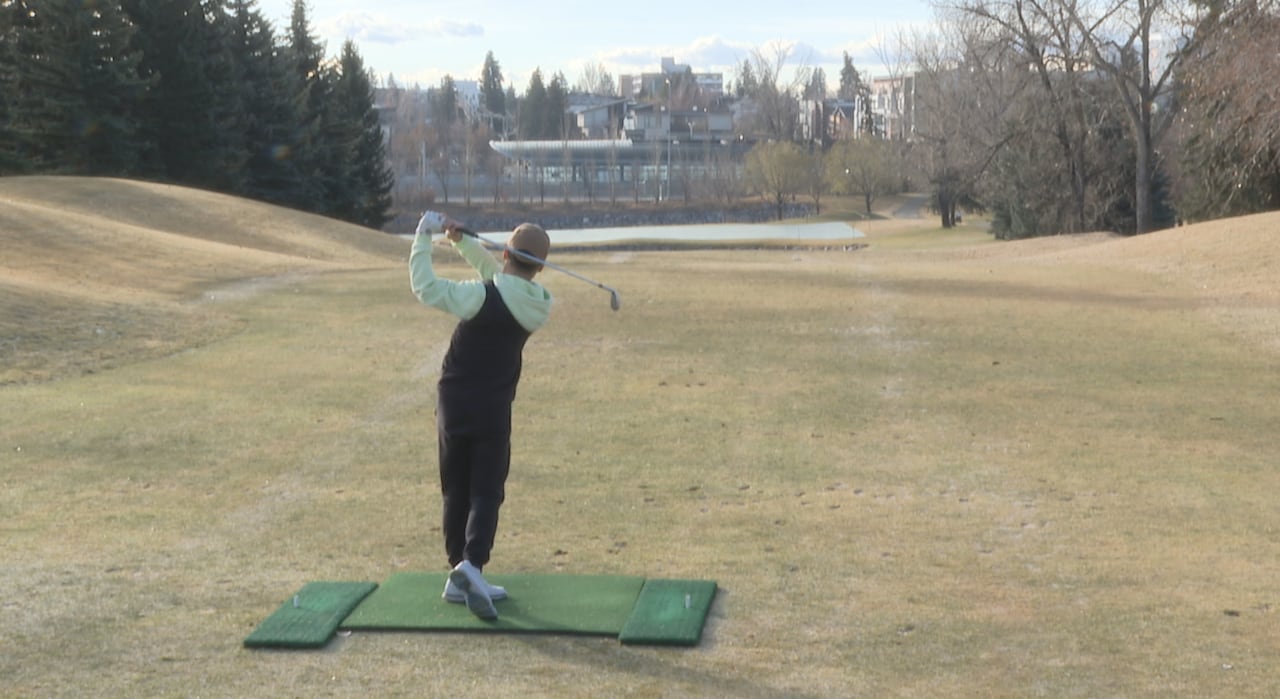 Golfer hitting a drive.