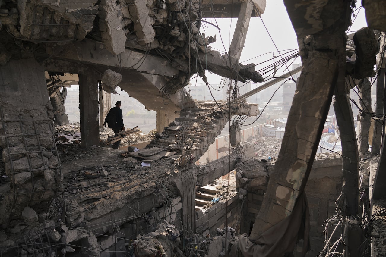 A person walks among rubble