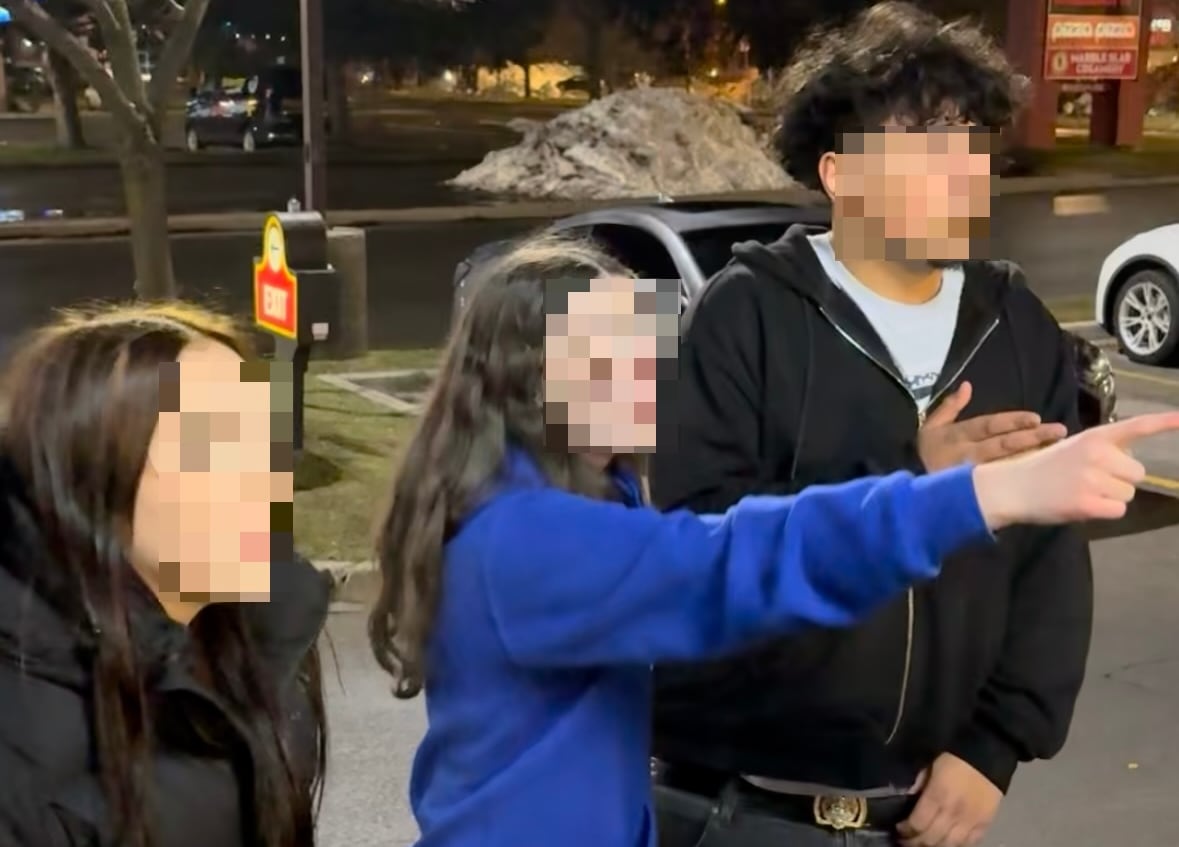 3 teens gesturing at someone off camera. Their faces are blurred as they are minors.