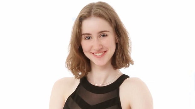 A young white woman in a black dress.