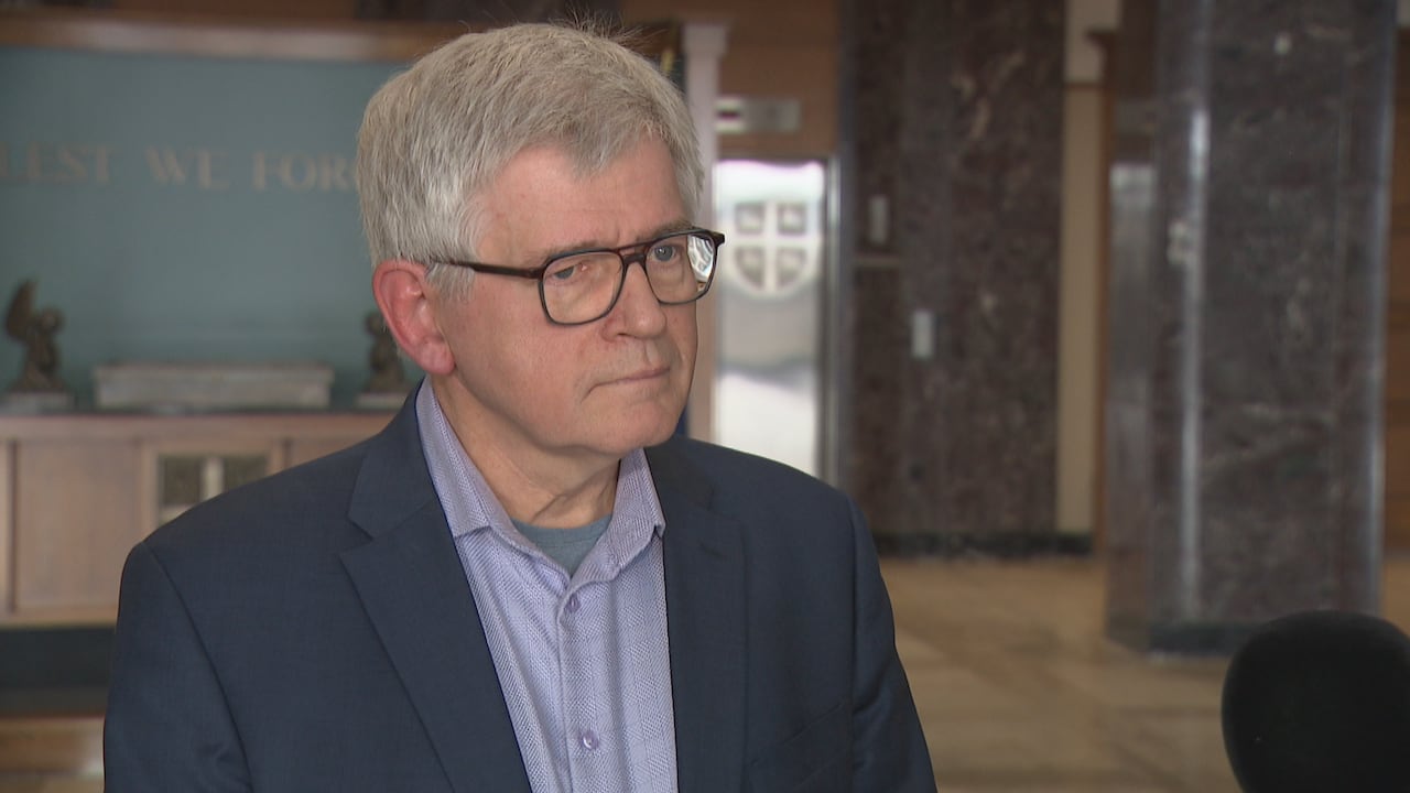 Man with glasses and wearing a suit.