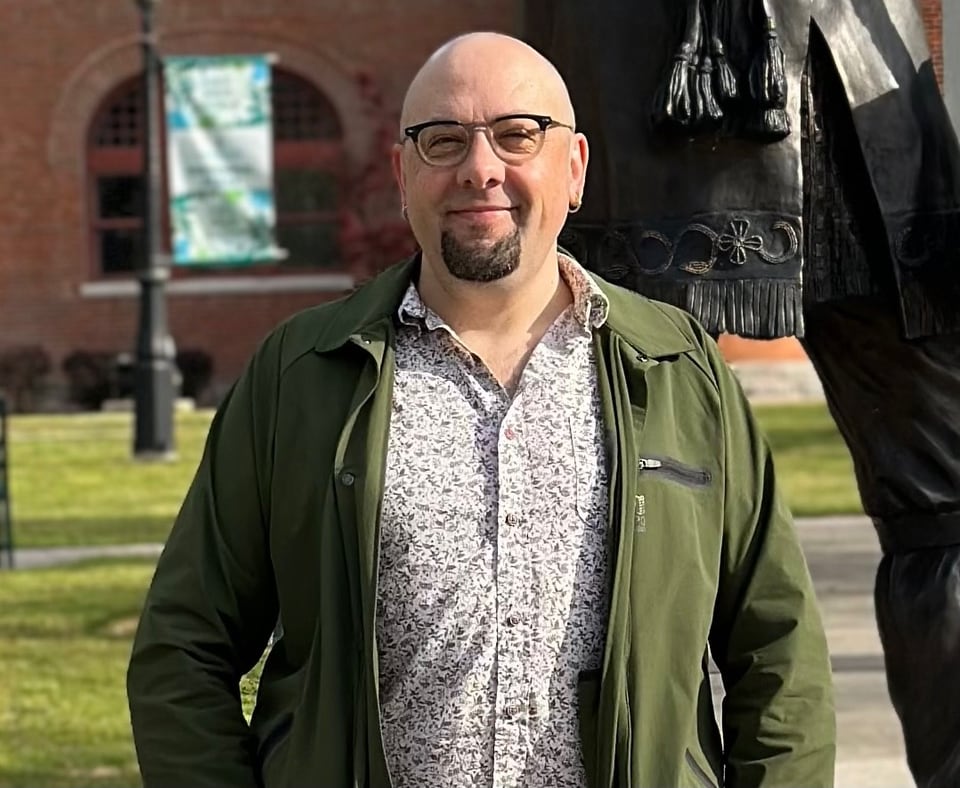 A man wearing glasses and a goatee