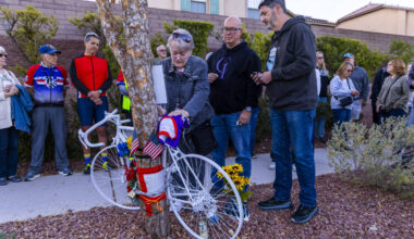 Linda Sterner and her son Shane, center, sign the bike dedicated to her husband and his father, ...