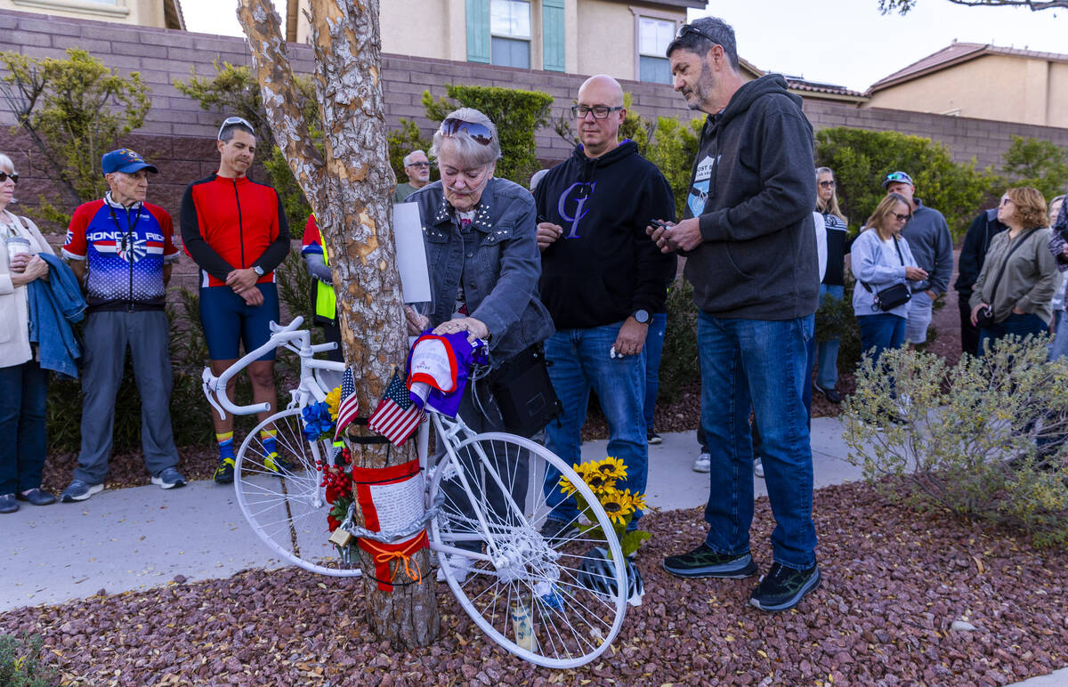 Linda Sterner and her son Shane, center, sign the bike dedicated to her husband and his father, ...