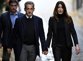 France's former president Nicolas Sarkozy (C), with his wife Carla Bruni-Sarkozy